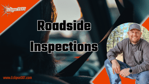 Image showing a commercial truck being inspected by a roadside inspector.