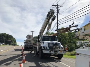Image of Eclipse DOT's truck fleet performing power line repairs, exemplifying the commitment to excellence in trucking services at the IAEC Fall Conference.