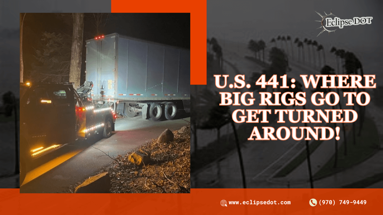 Tow truck assisting a stranded semi-truck on U.S. 441 at night.